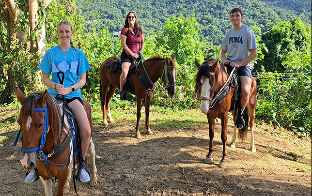 Three riders on horseback at Rainforest River Ride Adventure in El Yunque National Rainforest, Rio Grande, Puerto Rico